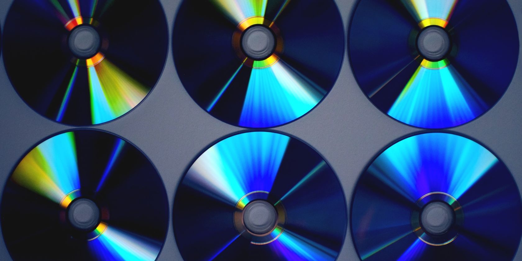 Six blank CD and DVD disks arranged in two rows