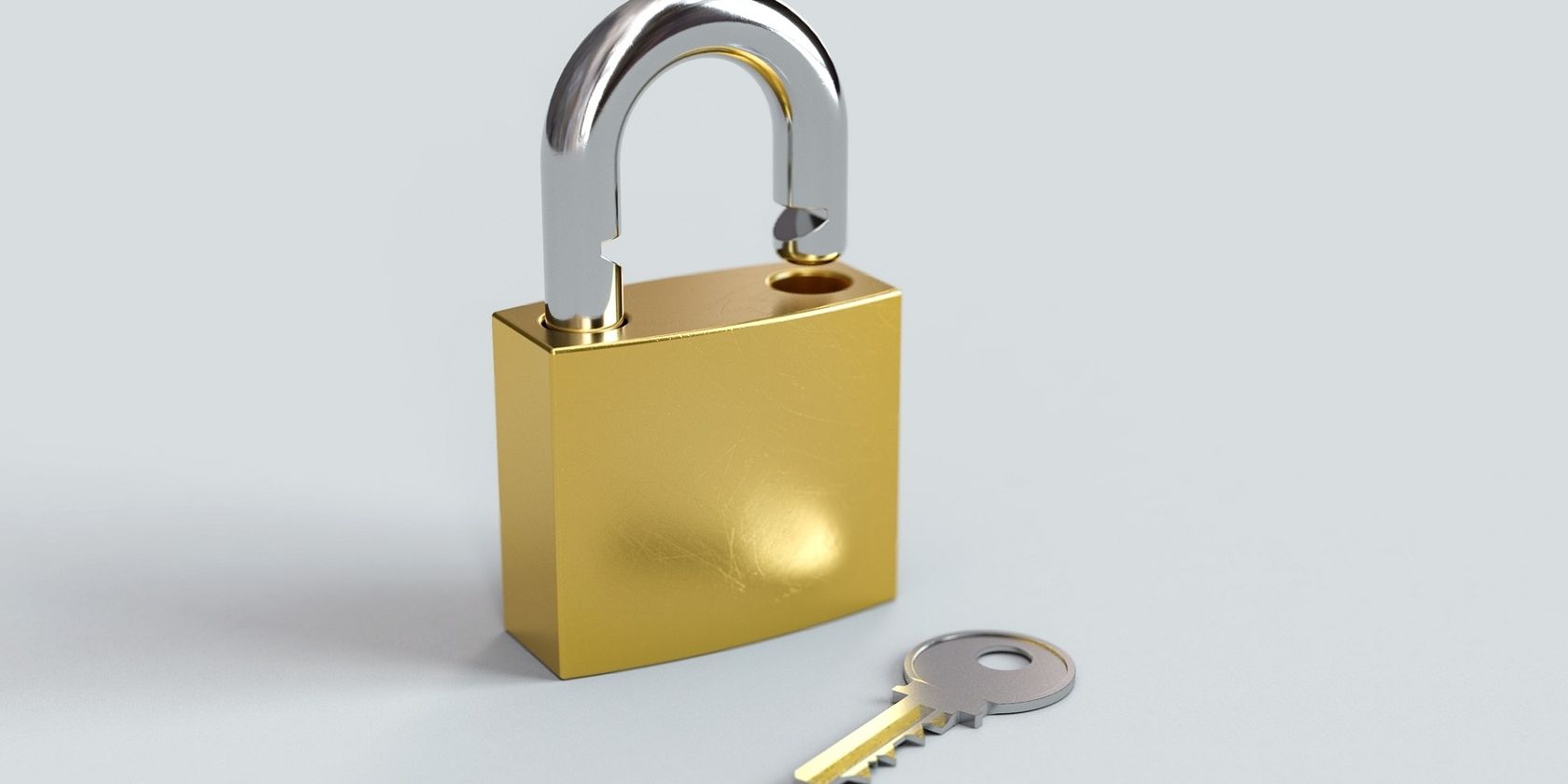 open padlock with key beside it