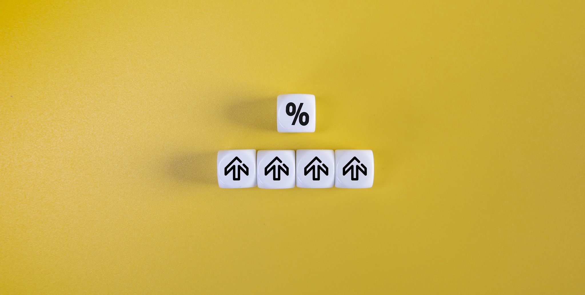 dice displaying percent logo and upward arrows on yellow background