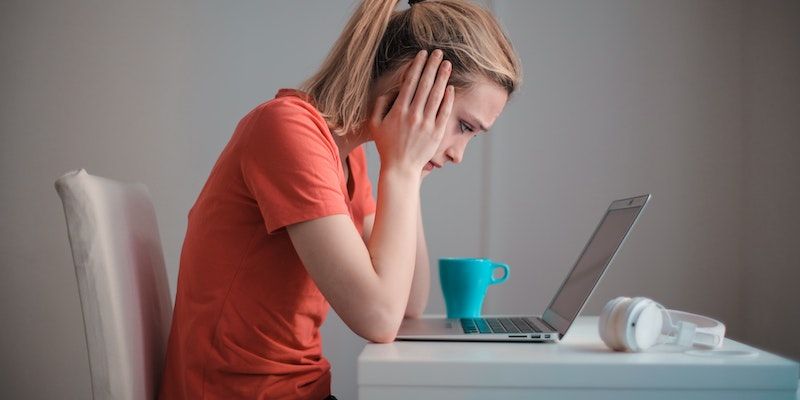 Unhappy woman behind a laptop
