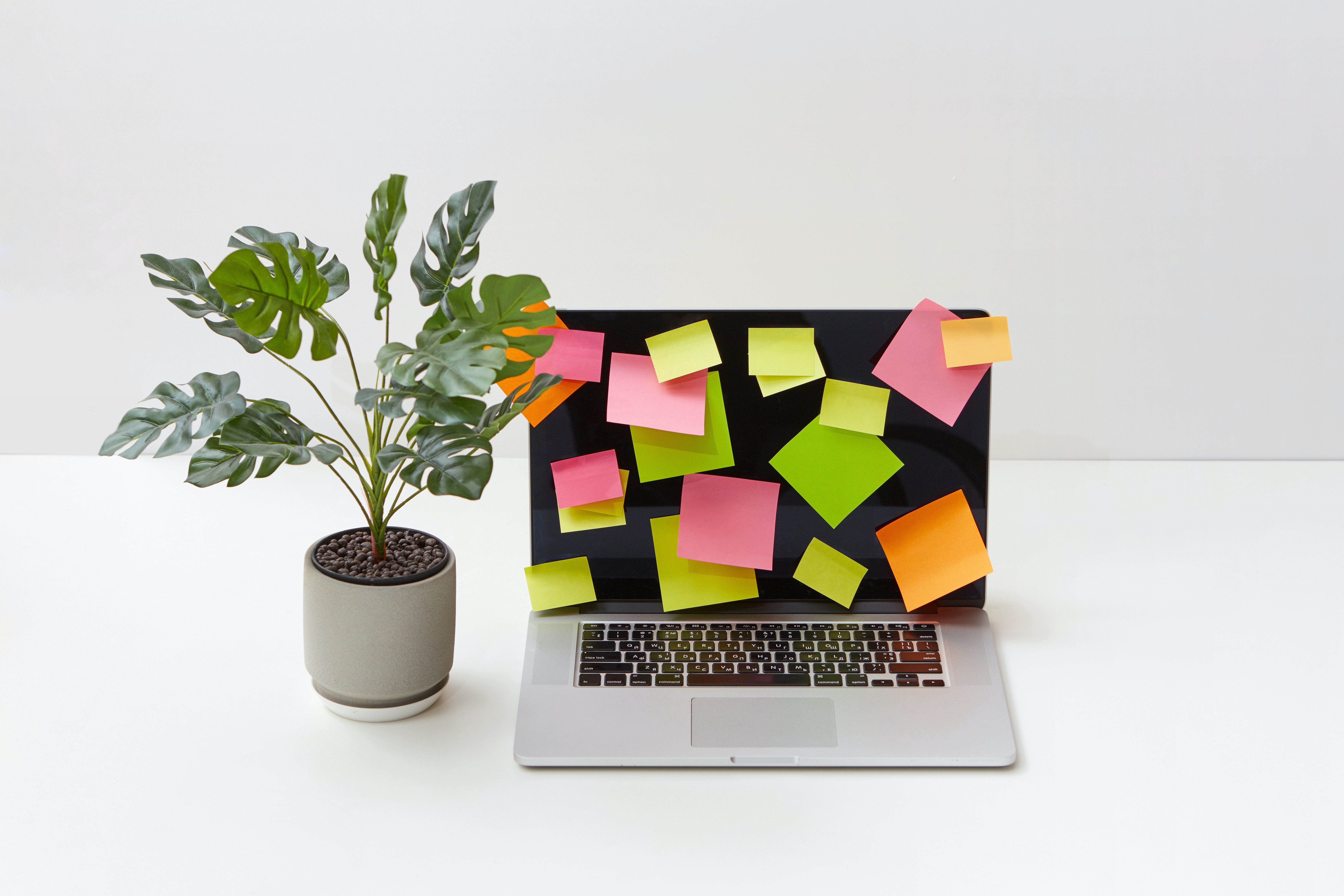 Laptop scattered with sticky notes