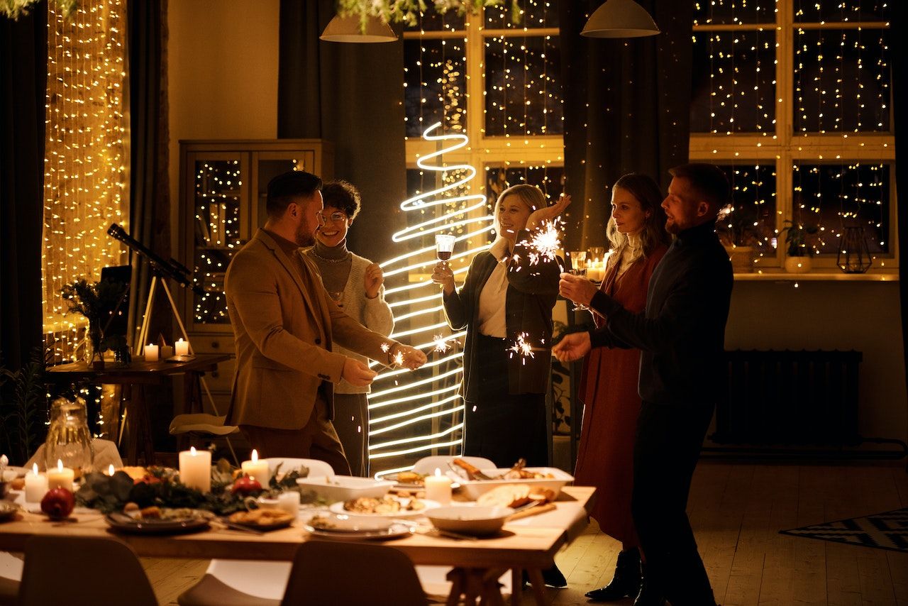 People Holding Sparklers and Enjoying at a Christmas Party 