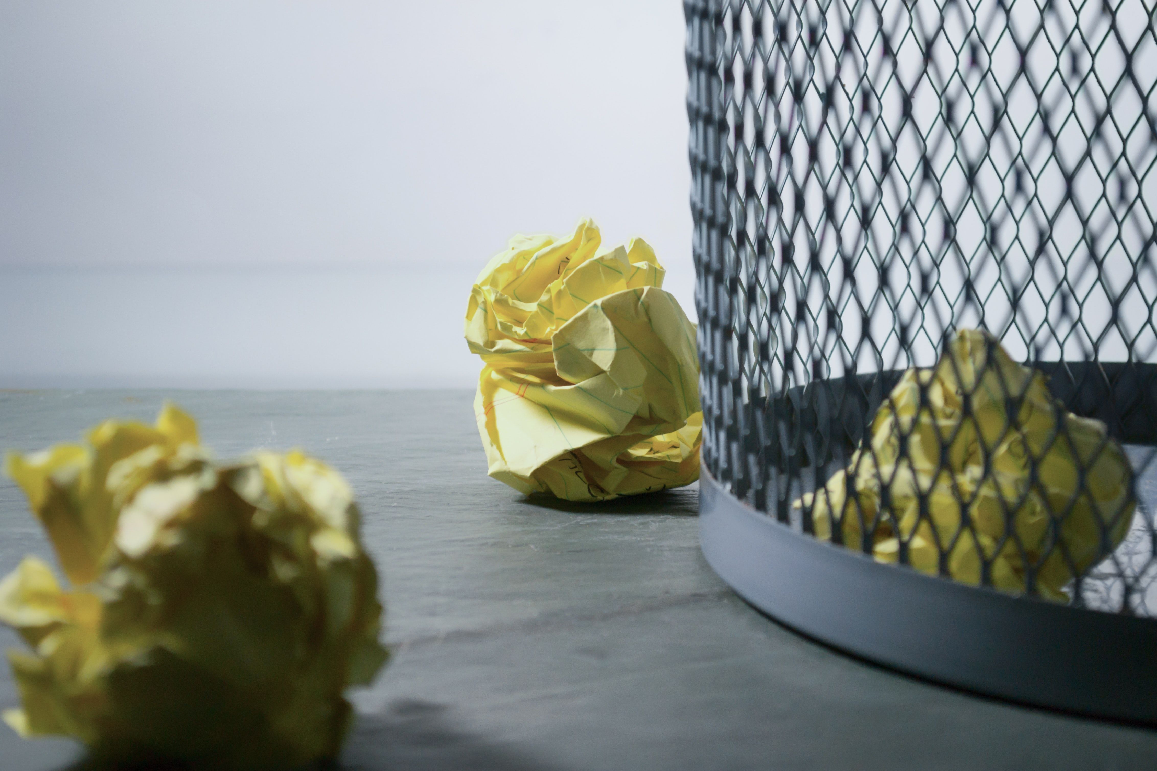 Yellow paper scrunched up in waste bin
