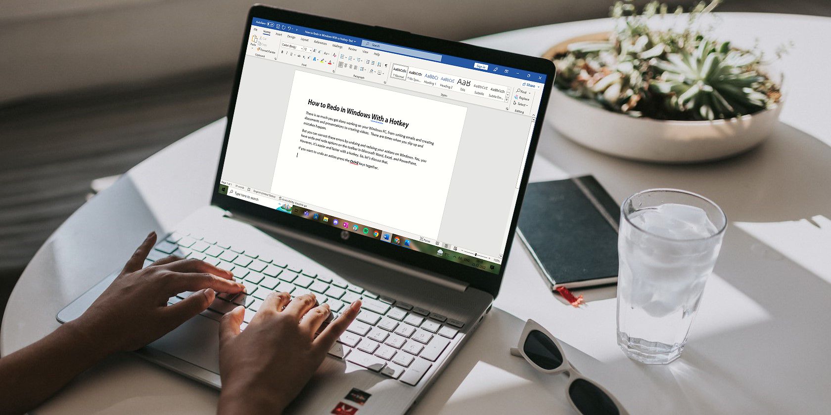 Person Working on a Word Document on a Windows Laptop