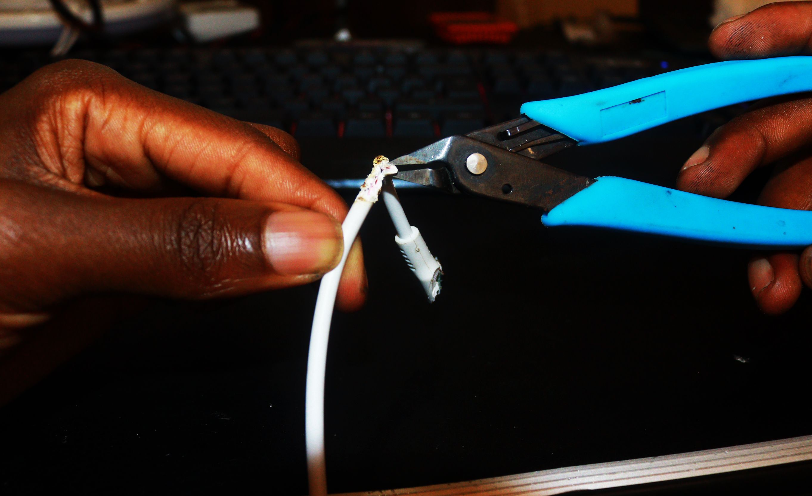 Using a cutting nippers to remove the outer covering of the cable