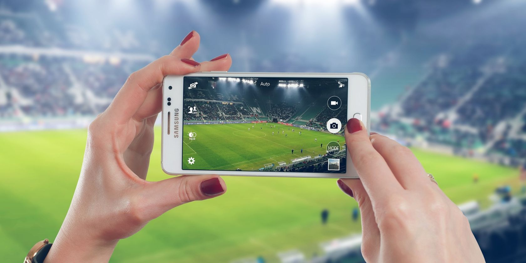 samsung phone being used to take photo of football game