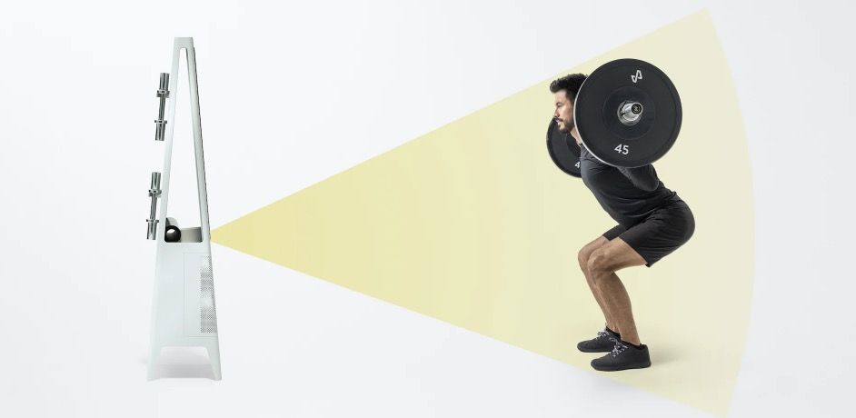 Man squatting in front of fitness mirror