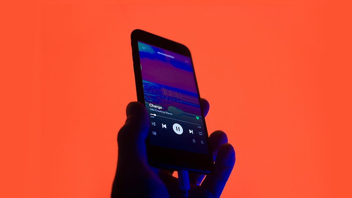 Playing Spotify on a phone with red background