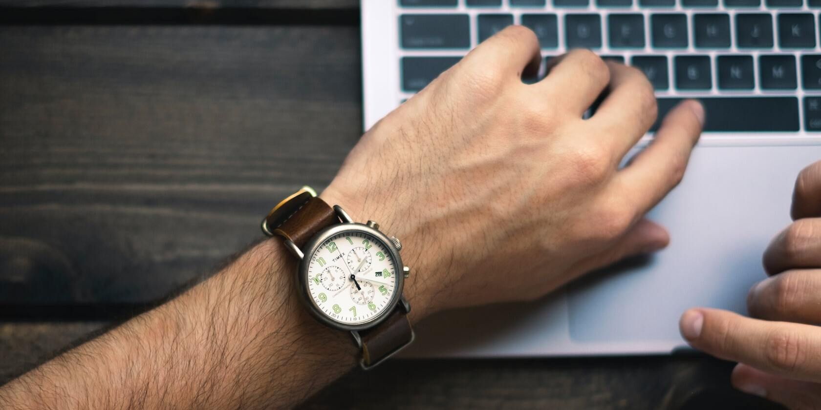 Wristwatch on a MacBook user's arm