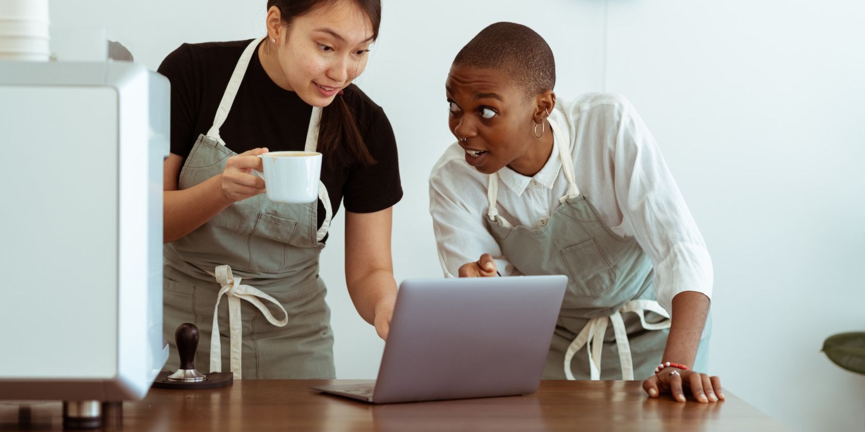 Two Surprised Workers Looking at Laptop Screen