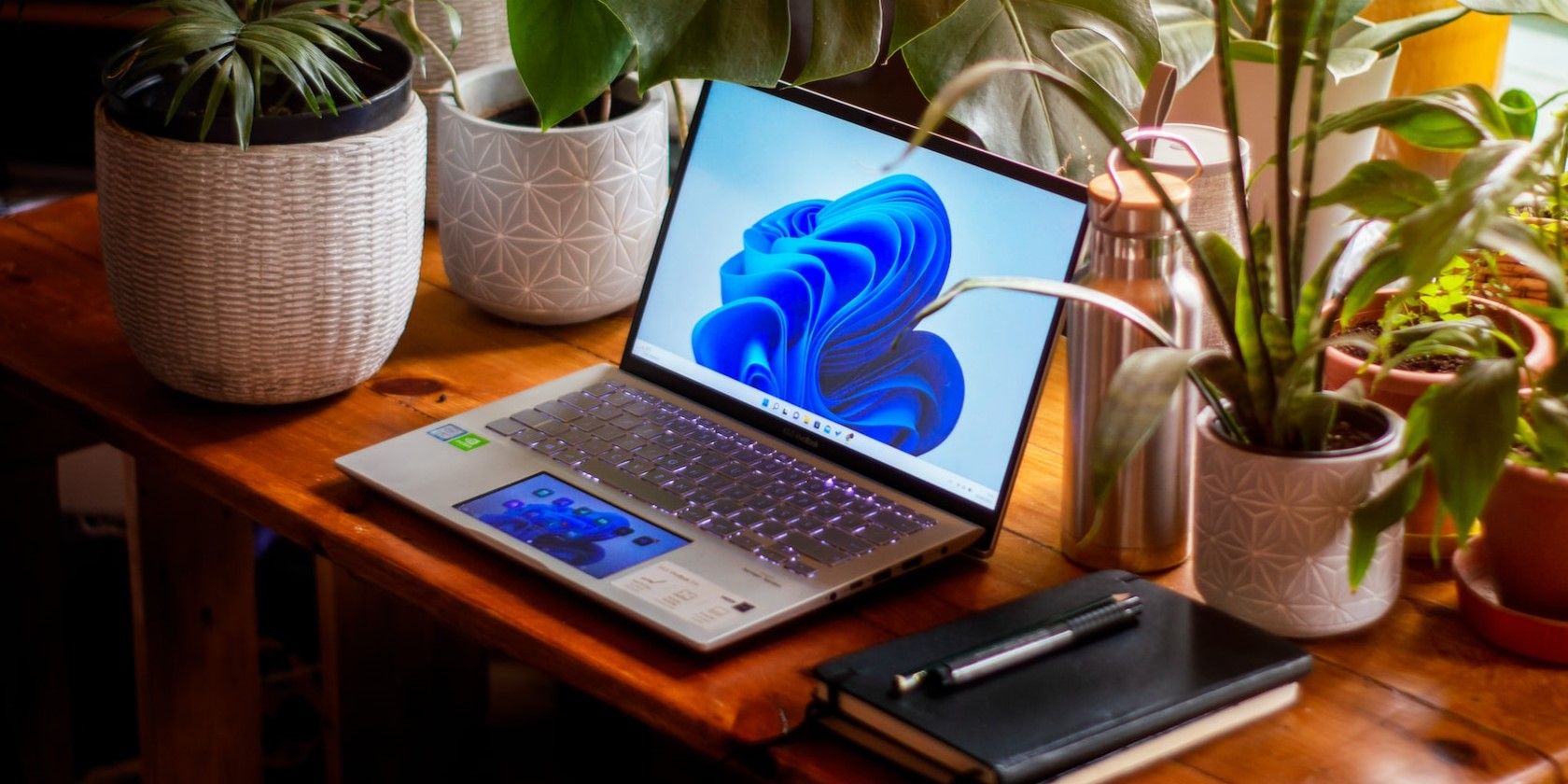 A silver Windows 11 laptop on a wooden table