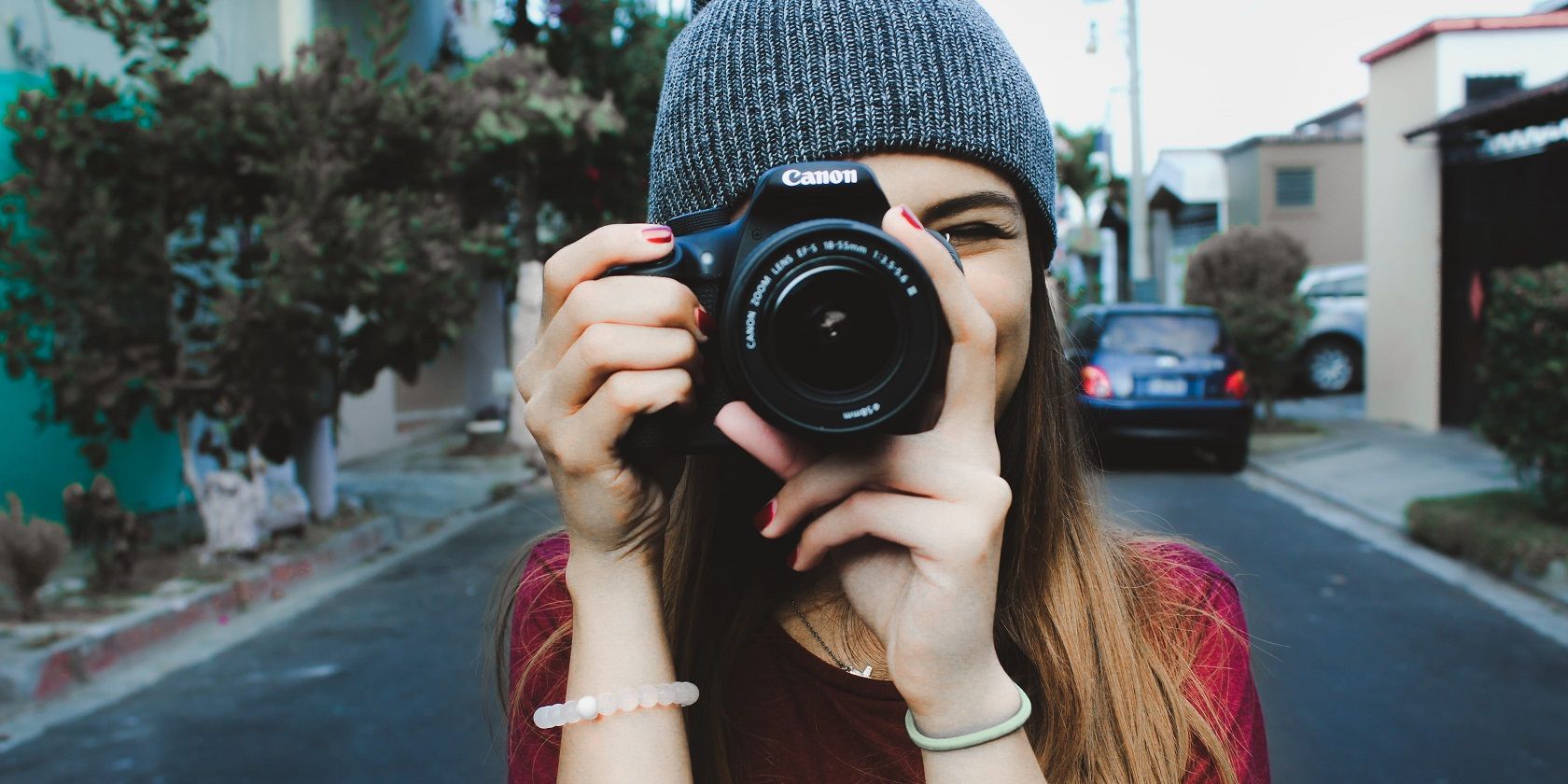 Woman Holding Camera in Street