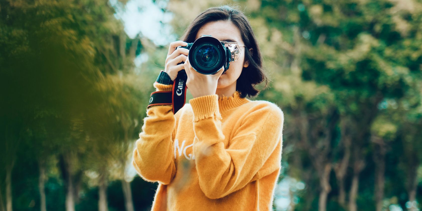 photo of a woman taking photos on a camera