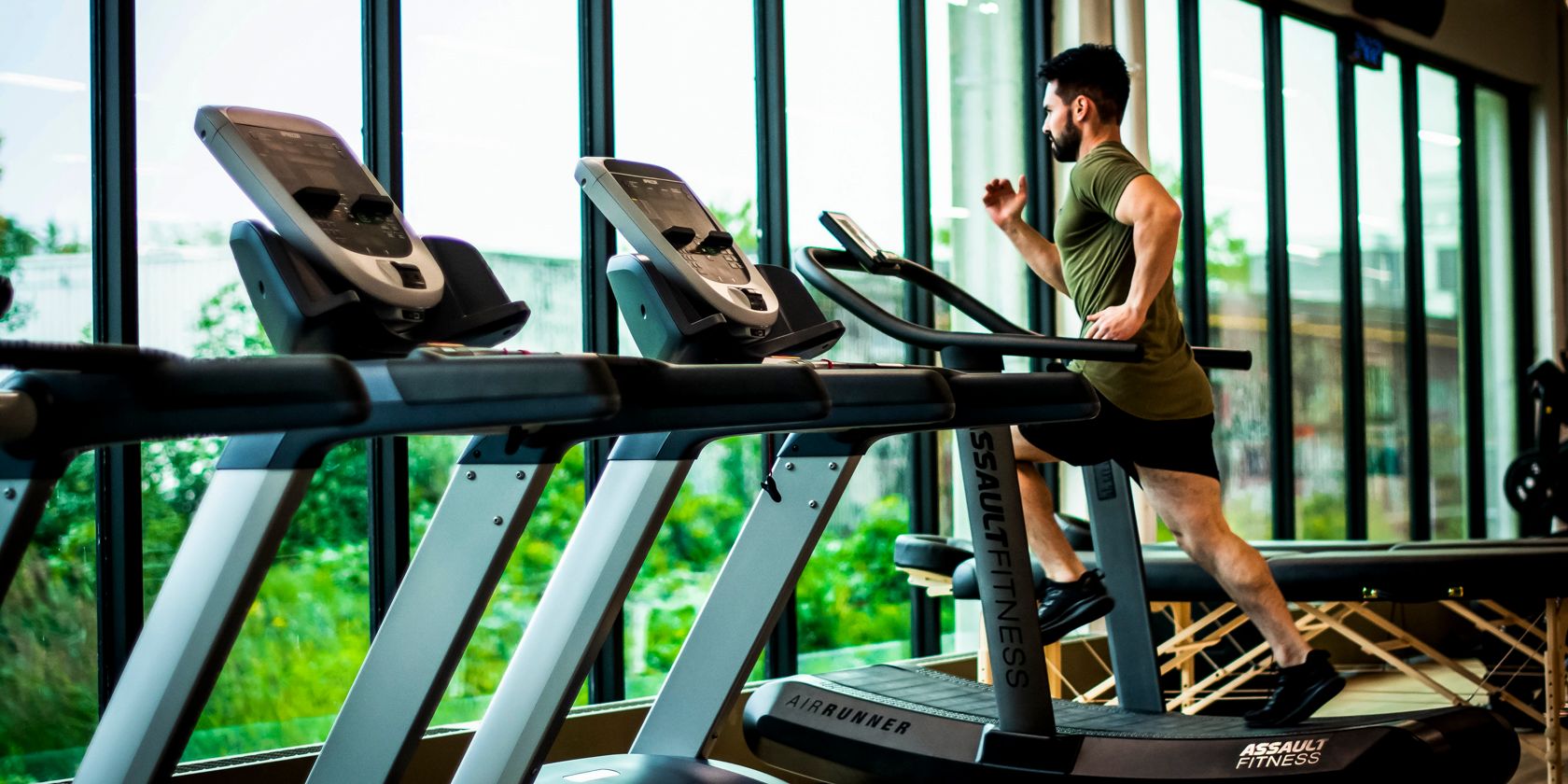 a man doing running on a treadmill in a gym