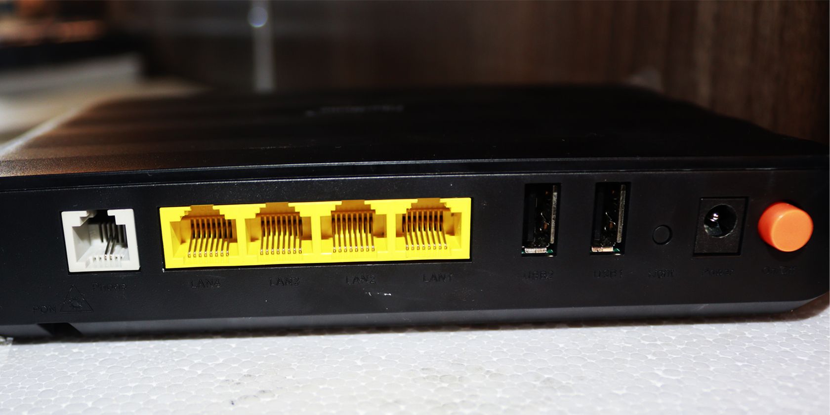The rear of a black router showing the ports