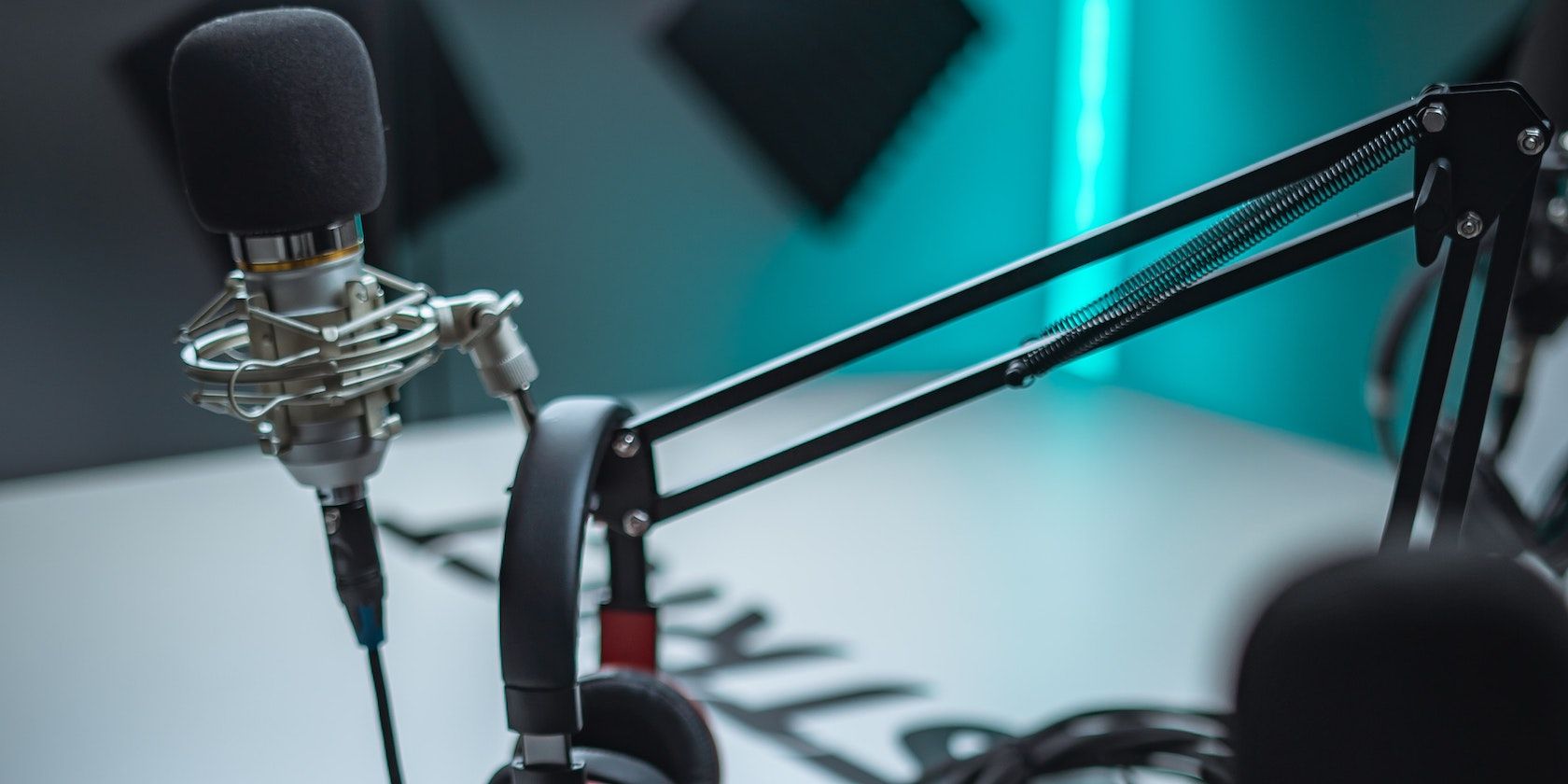 a studio microphone and headphones on the stand