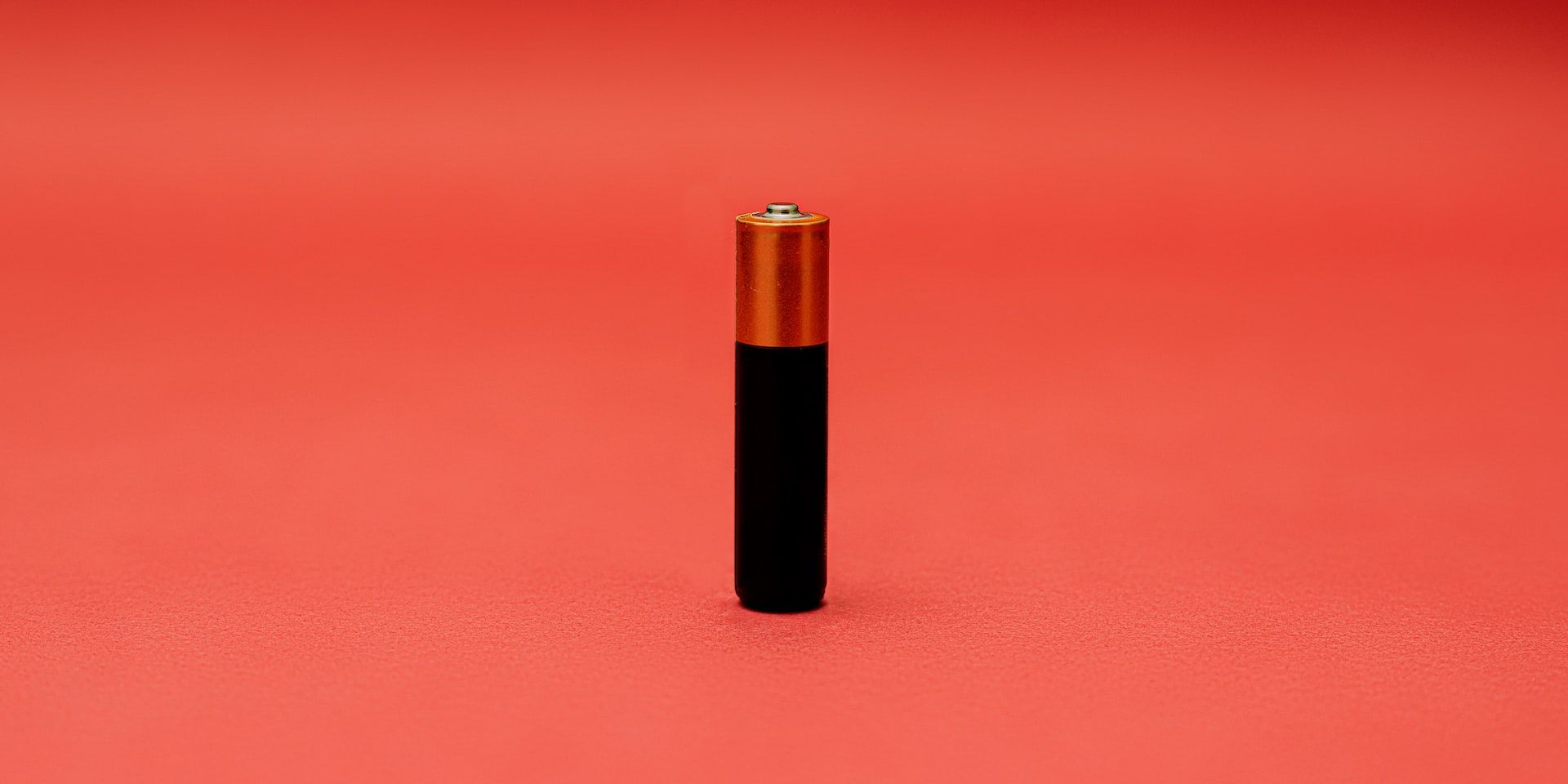 AA battery on red background
