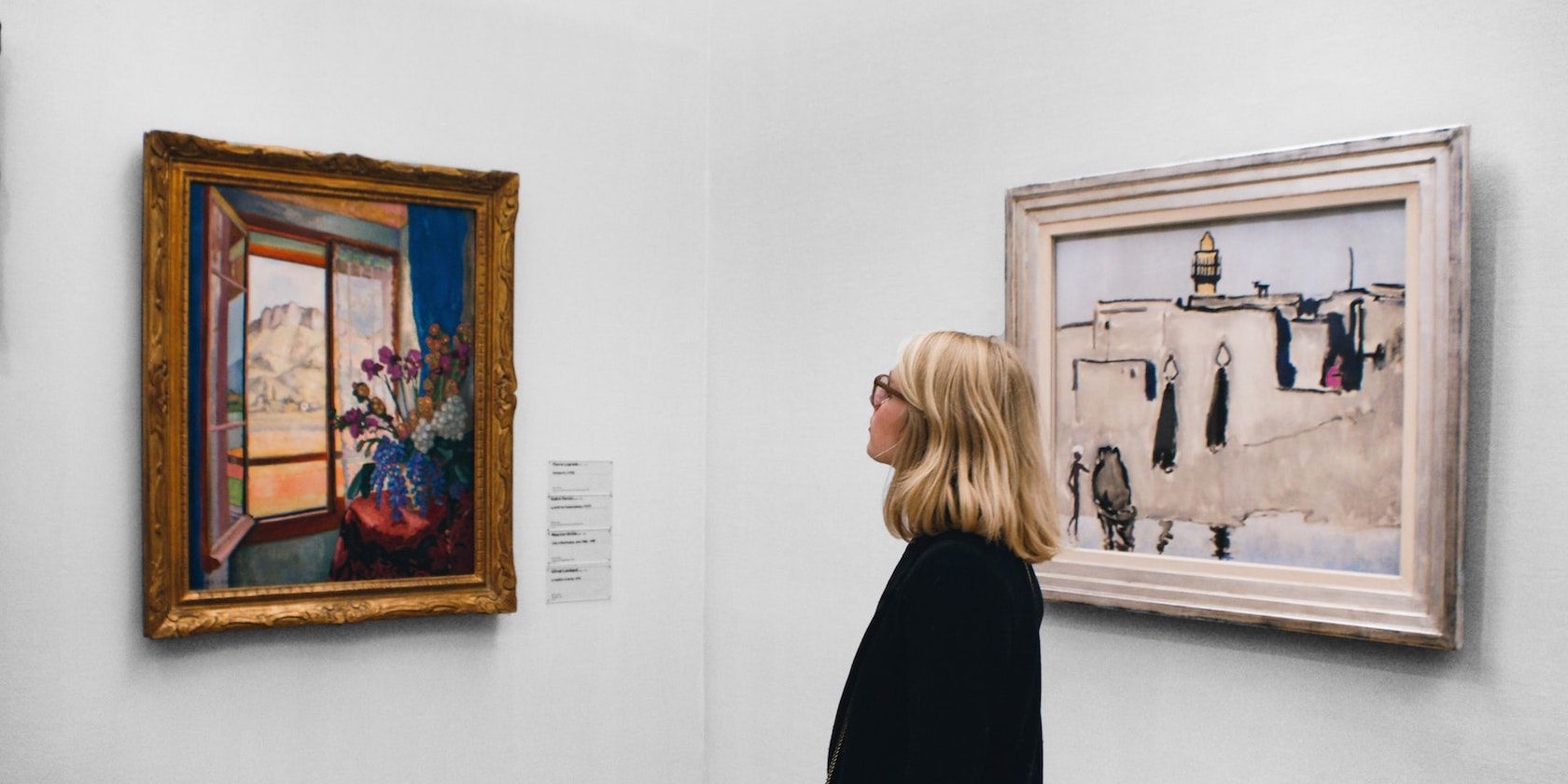 A woman looking at a piece of art.