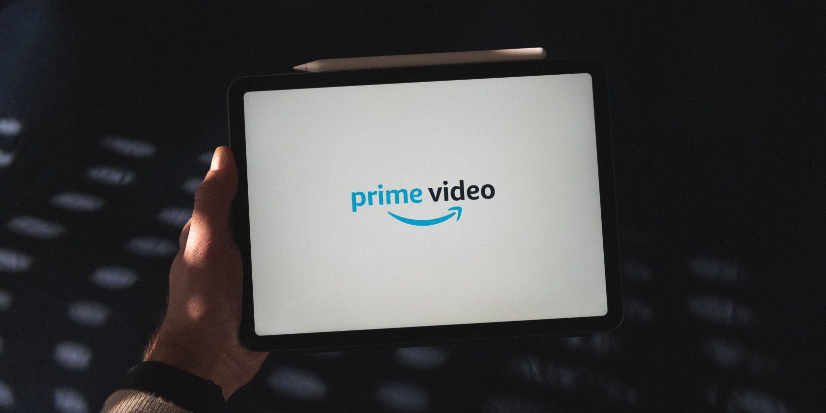 person holding tablet with amazon prime video logo