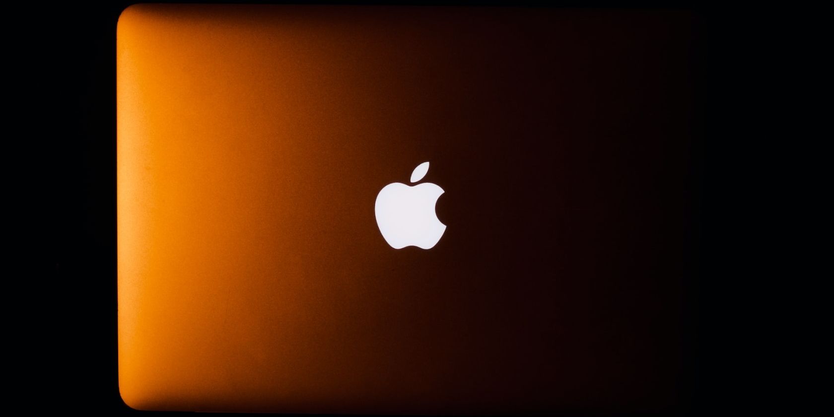 Backlit Apple logo on a MacBook