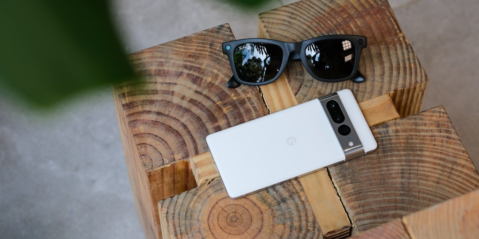 the google pixel 7 next to a pair of sunglasses, atop a stool