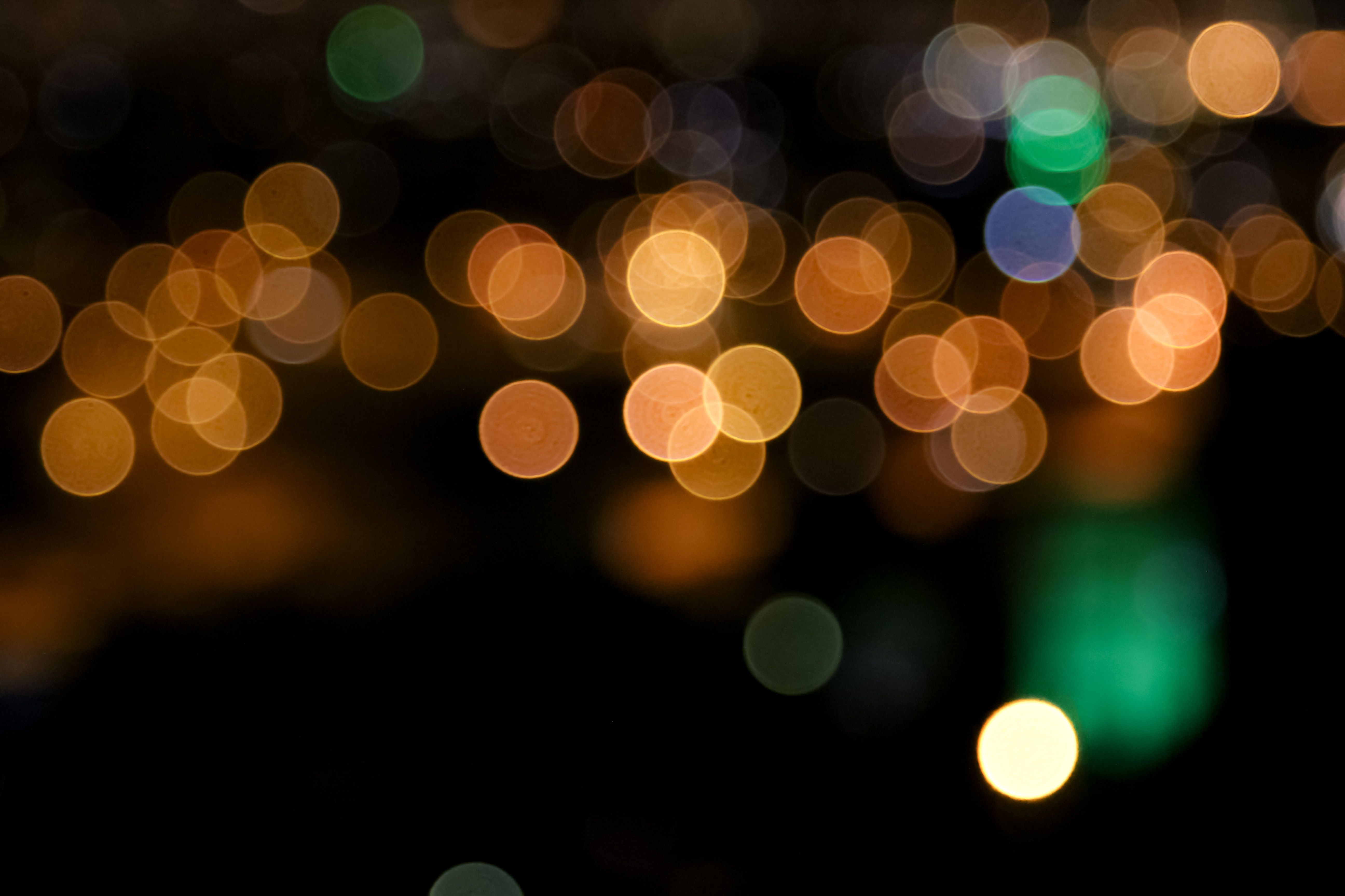 Orange bokeh background with touches of green