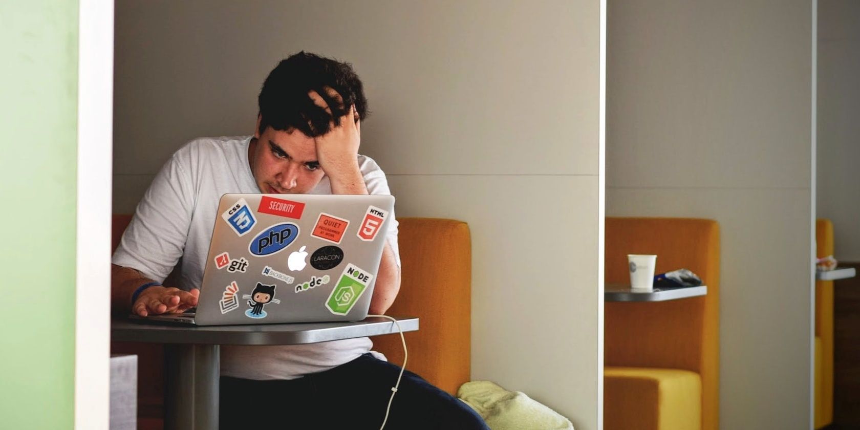 Boy looking at his laptop in frustration