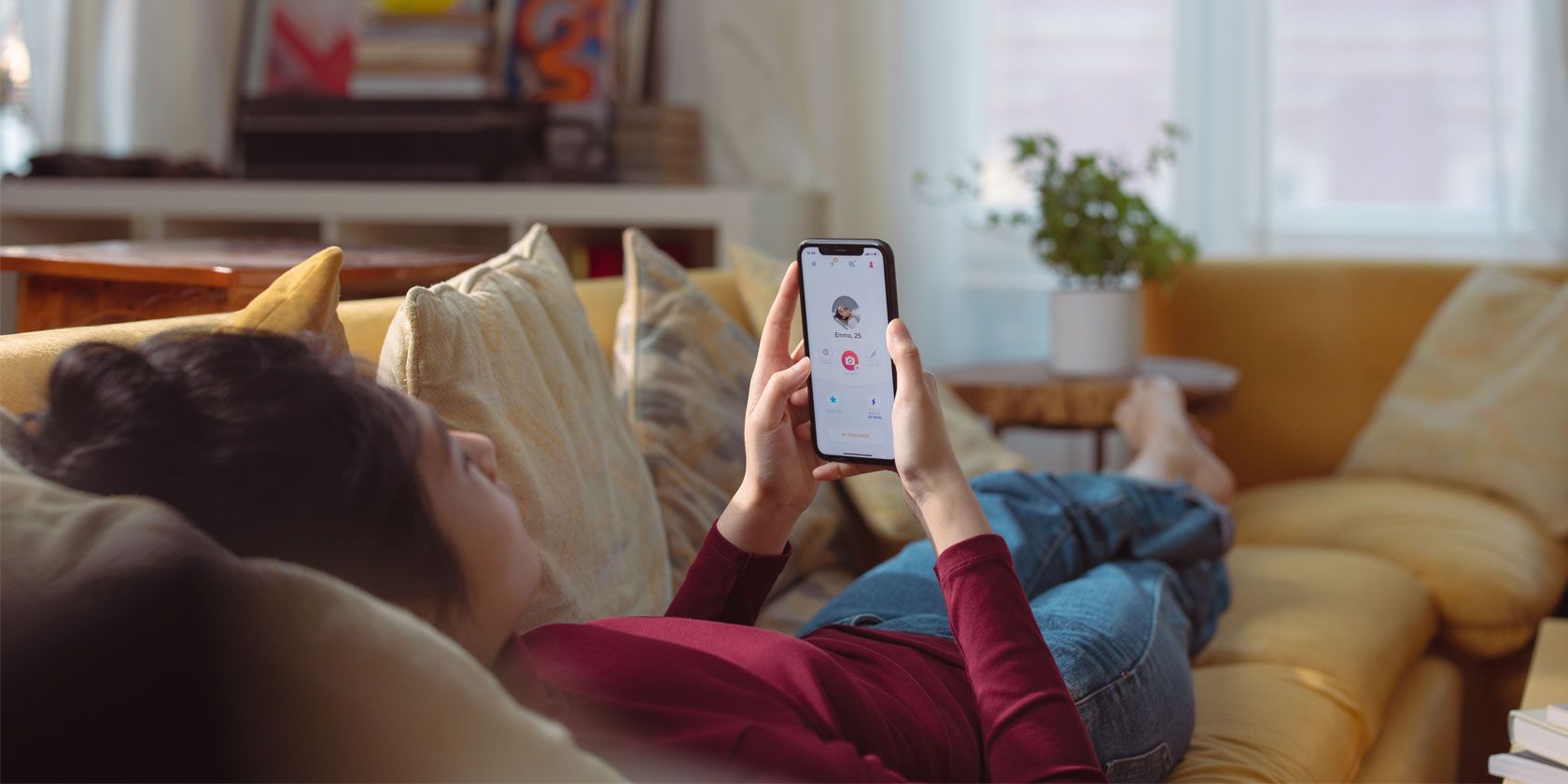 Woman on couch browsing a dating app