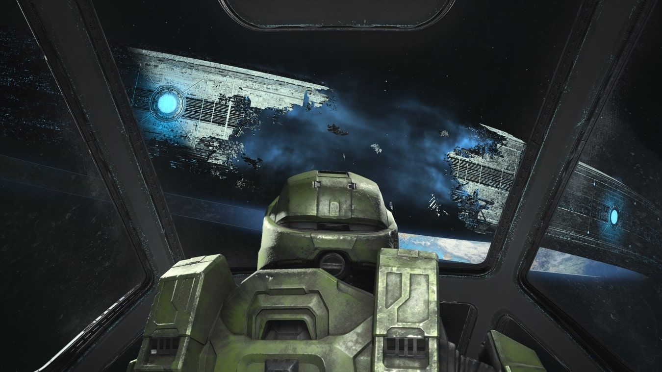 A screenshot from mission one of Halo Infinite highlighting Master Chief looking at a broken Halo ring 