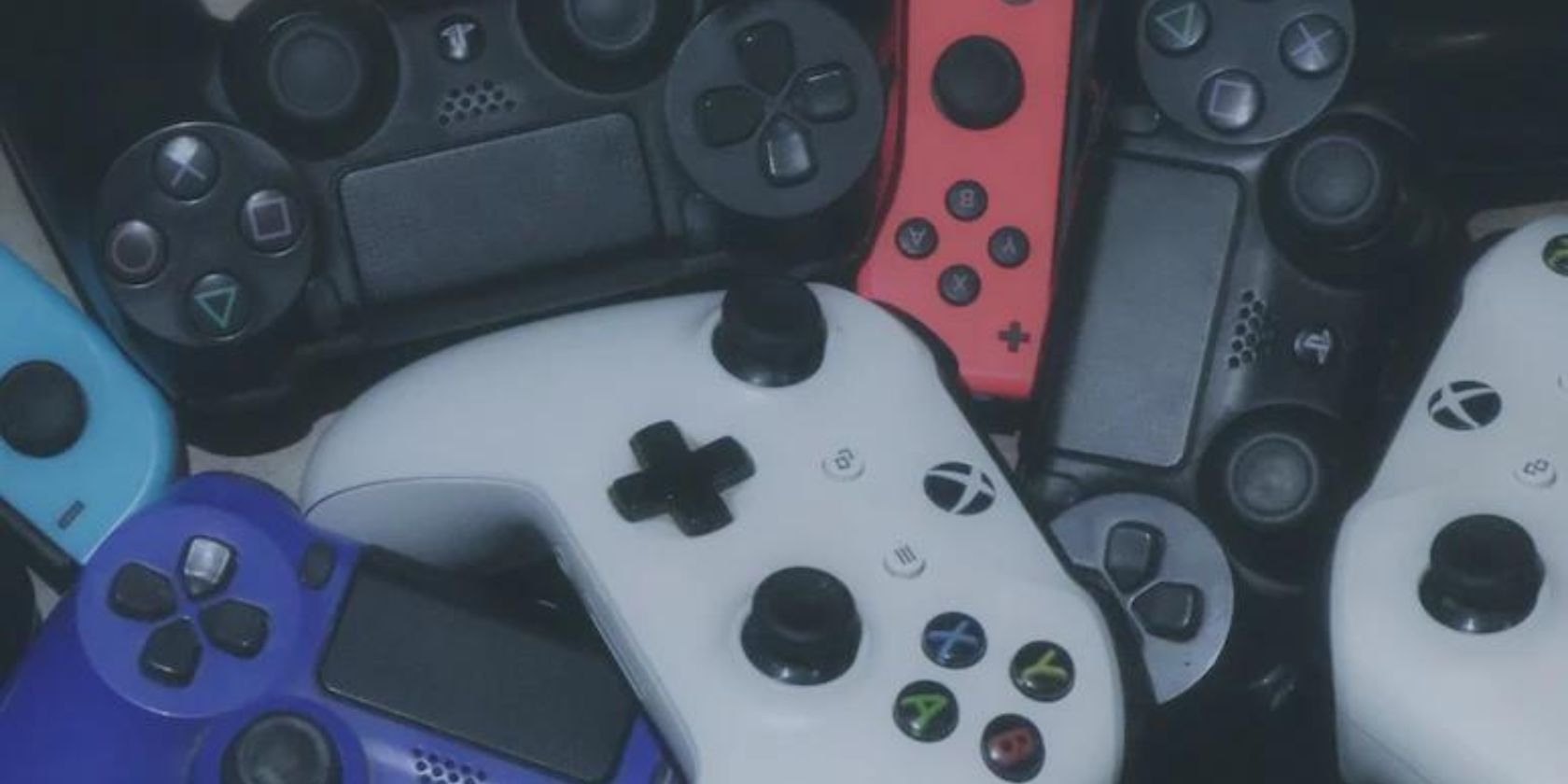 Close up shot of many different gaming controllers