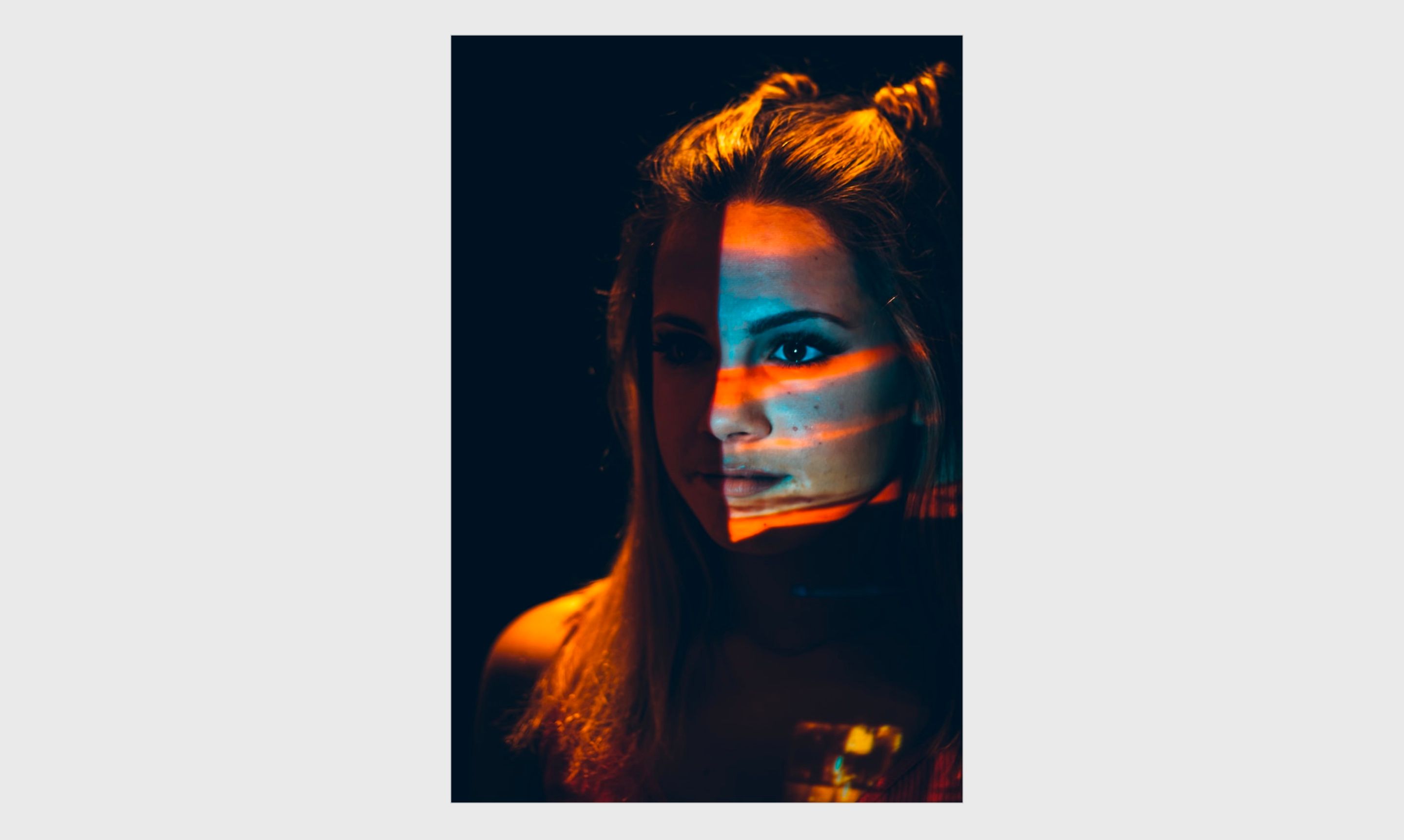 Self portrait of a woman with colored lights on her face