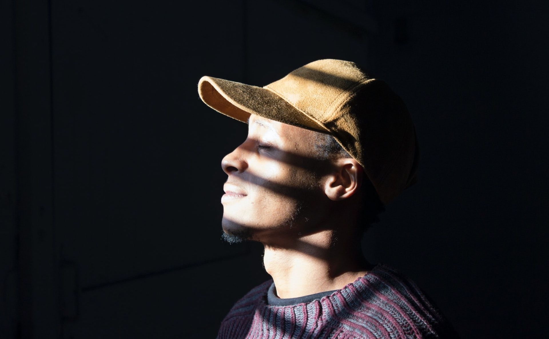 Self portrait of a man with shadows cast across his face