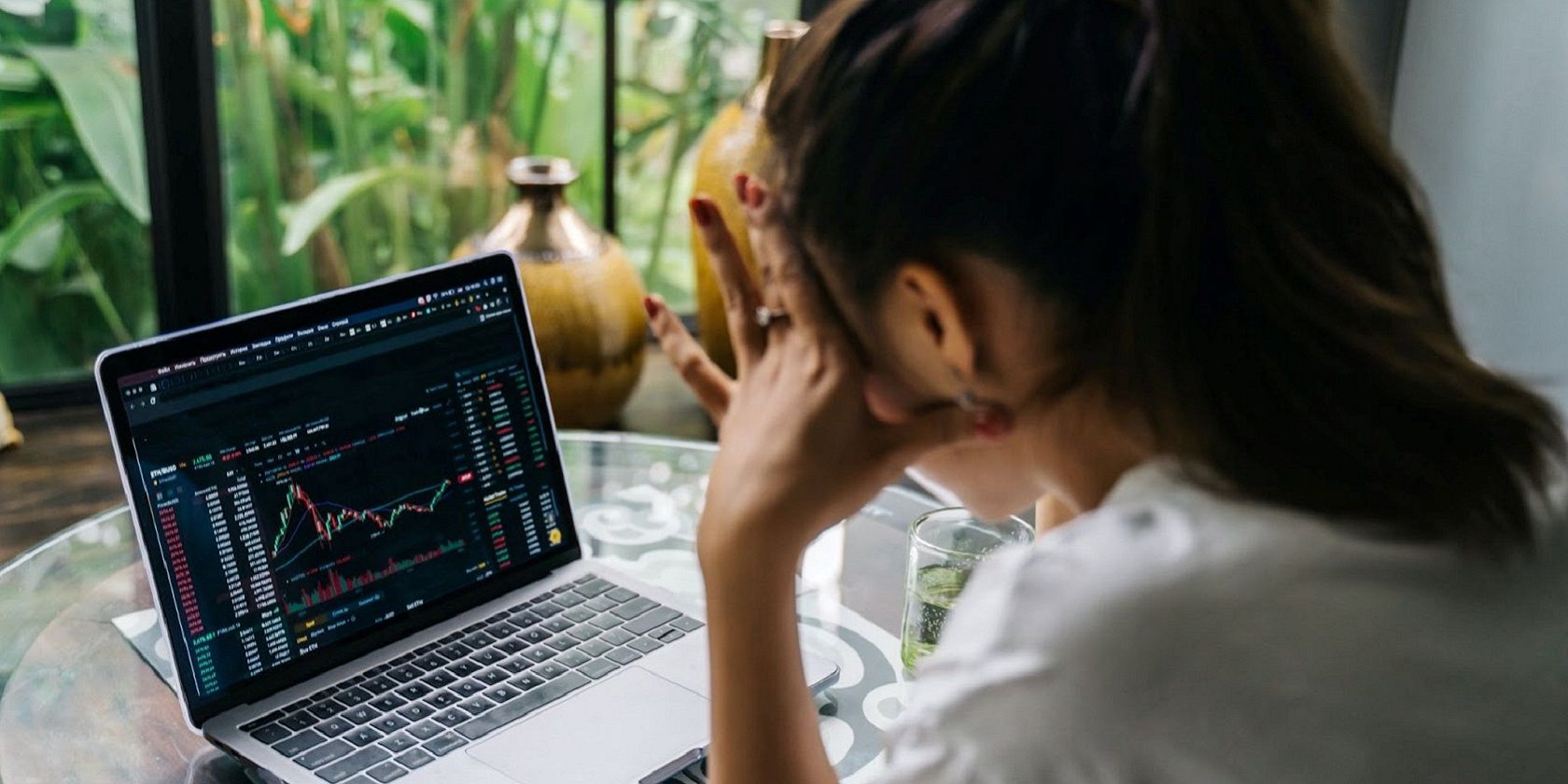 A woman observing a crypto chart on her laptop