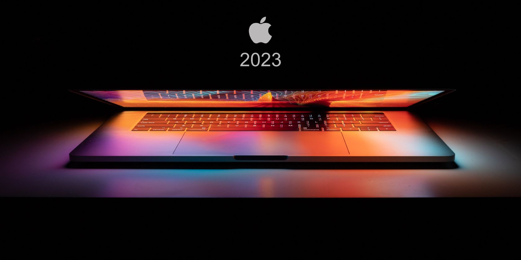 Feature image with half closed MacBook underneath Apple logo 2023