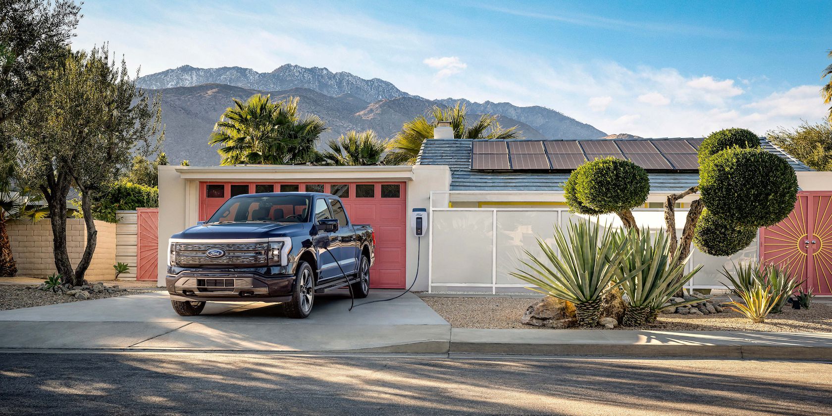 F-150 Lightning attached to a house with solar panels.