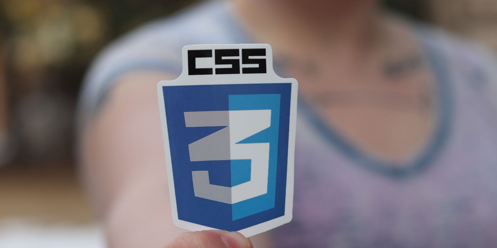 hand holding CSS3 icon