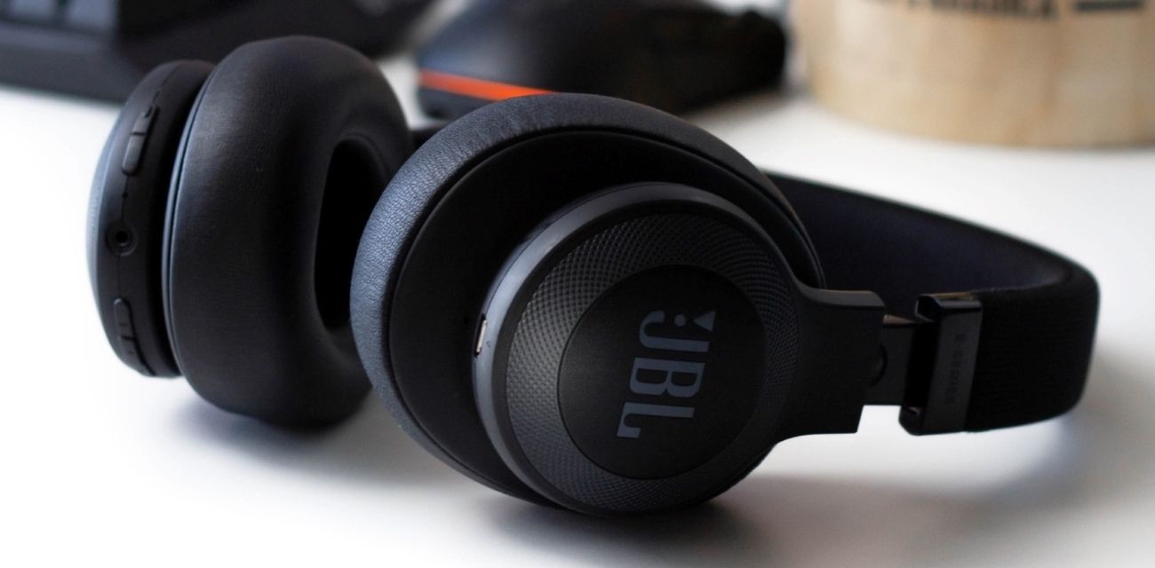 A picture of black JBL headphones on a table. 