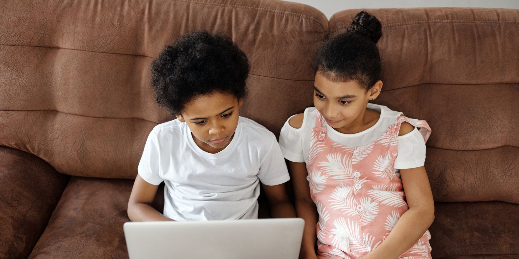 Kids watching video on laptop