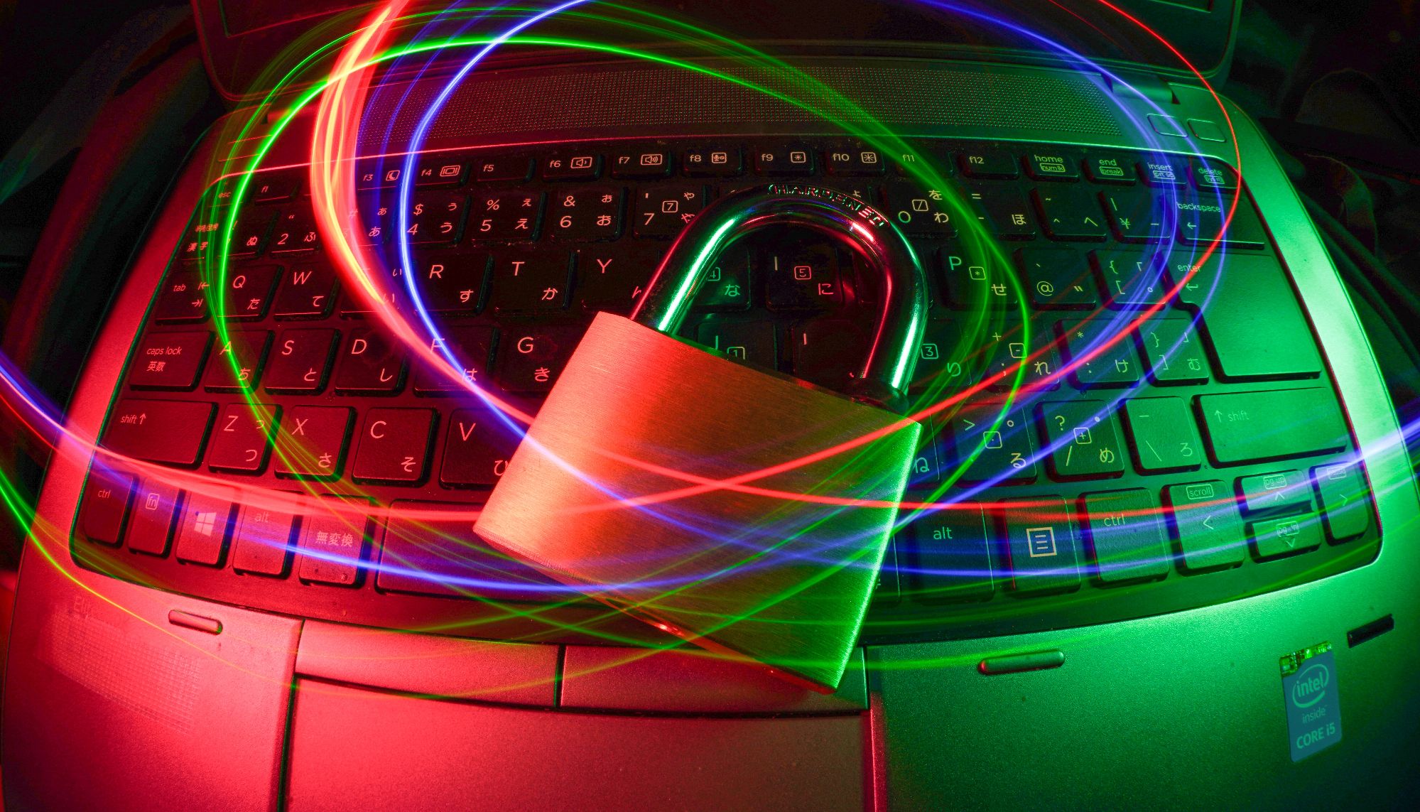 padlock on laptop with multi colored lines surrounding