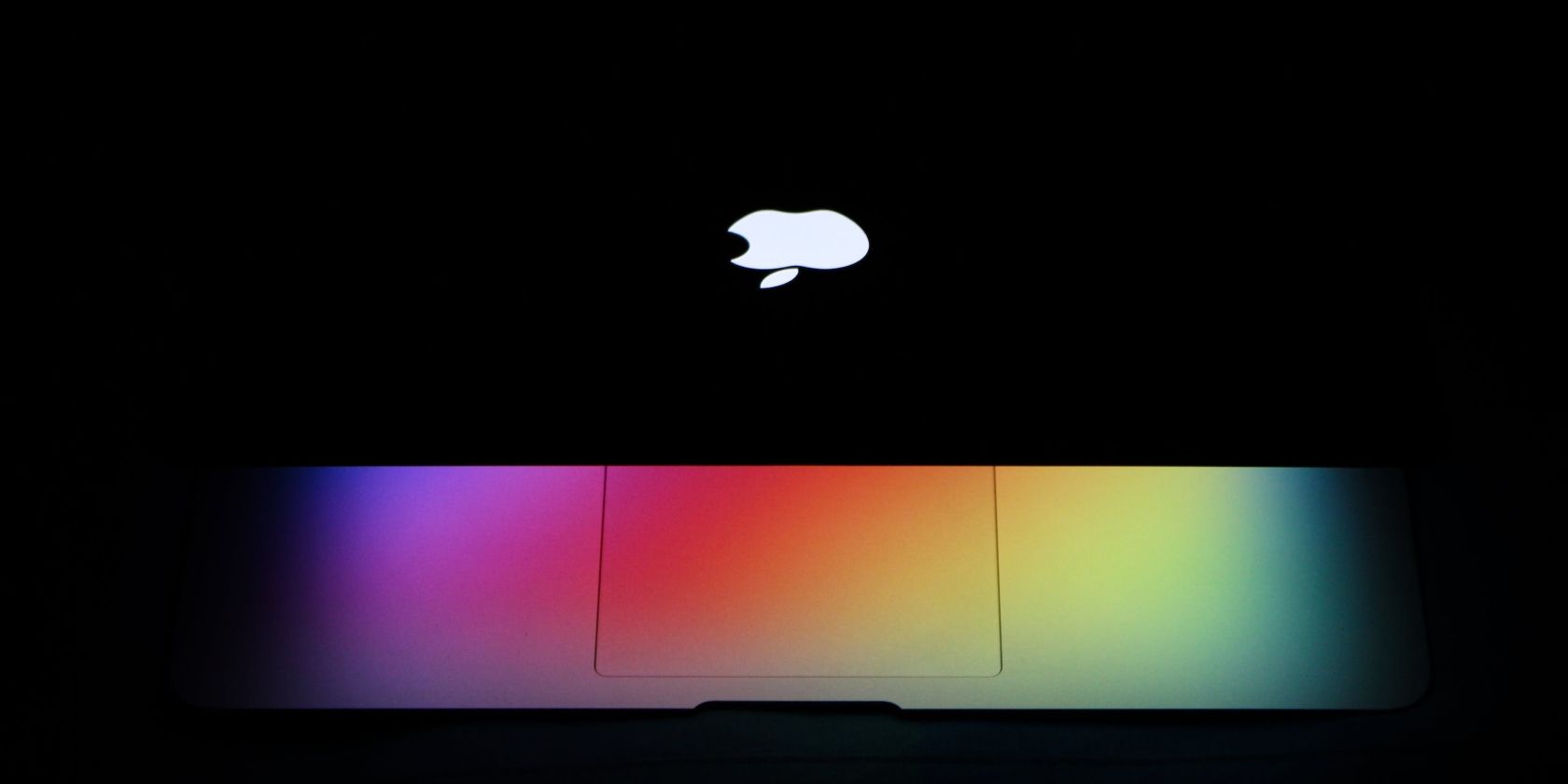 MacBook under rainbow colored lighting