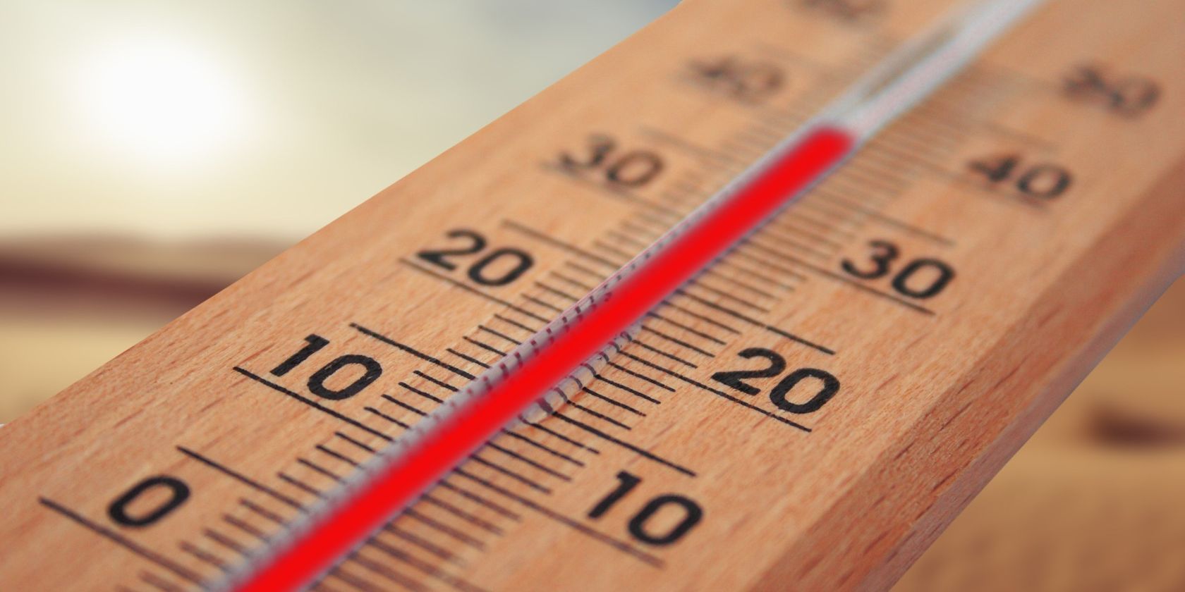 wooden thermometer with red line showing temperature