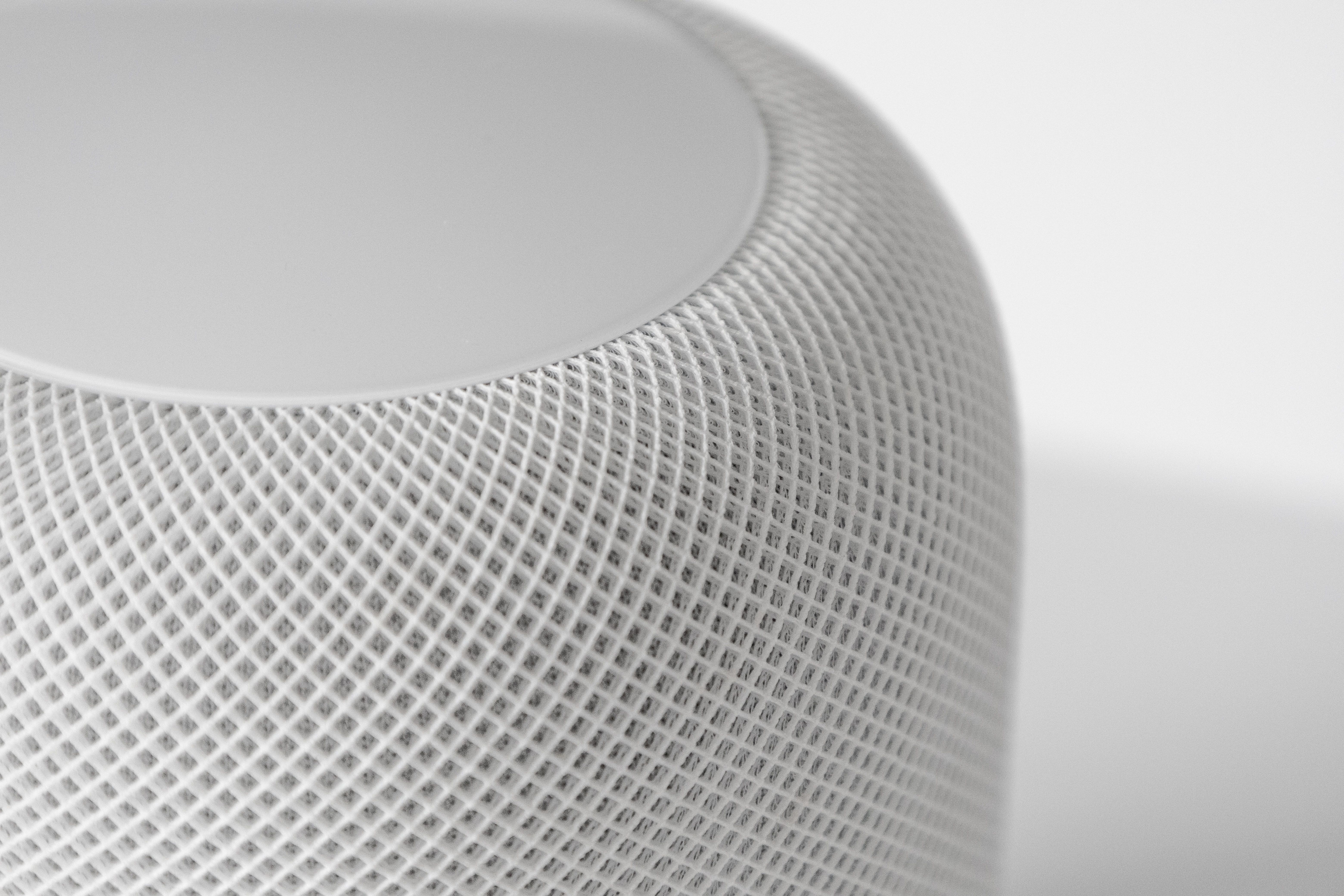Close-up shot white HomePod on a white table 