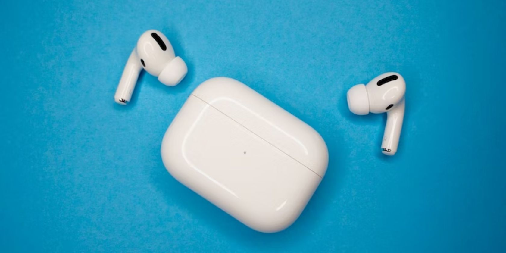 airpods pro and case against blue background