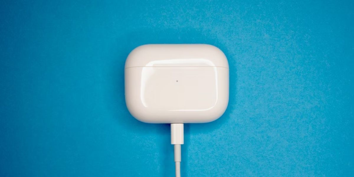 charging airpods against blue background