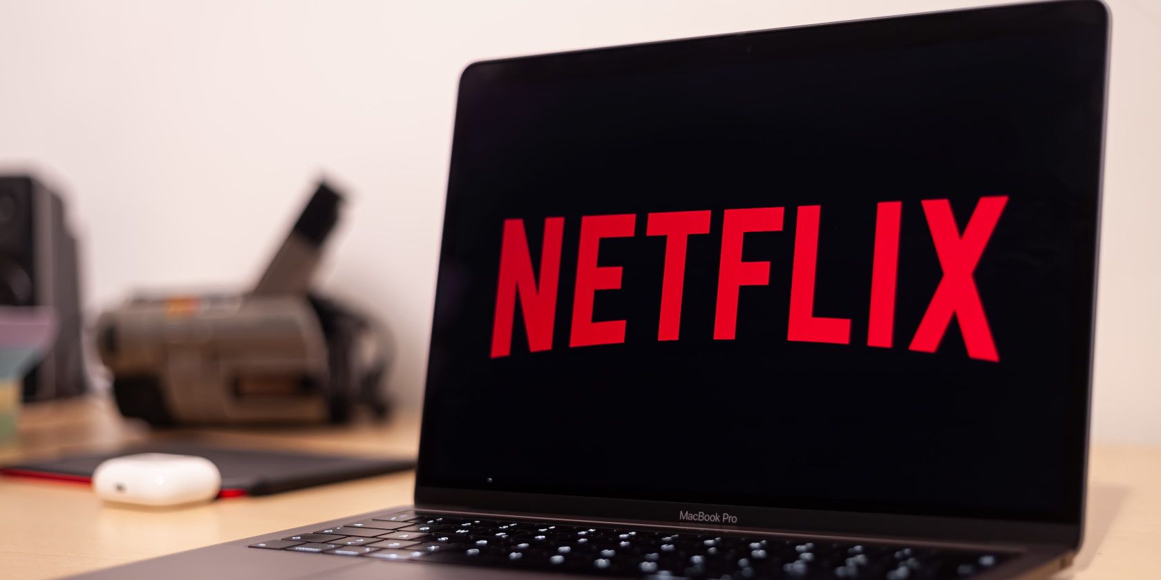 Close up of open MacBook laptop with Netflix streaming service logo