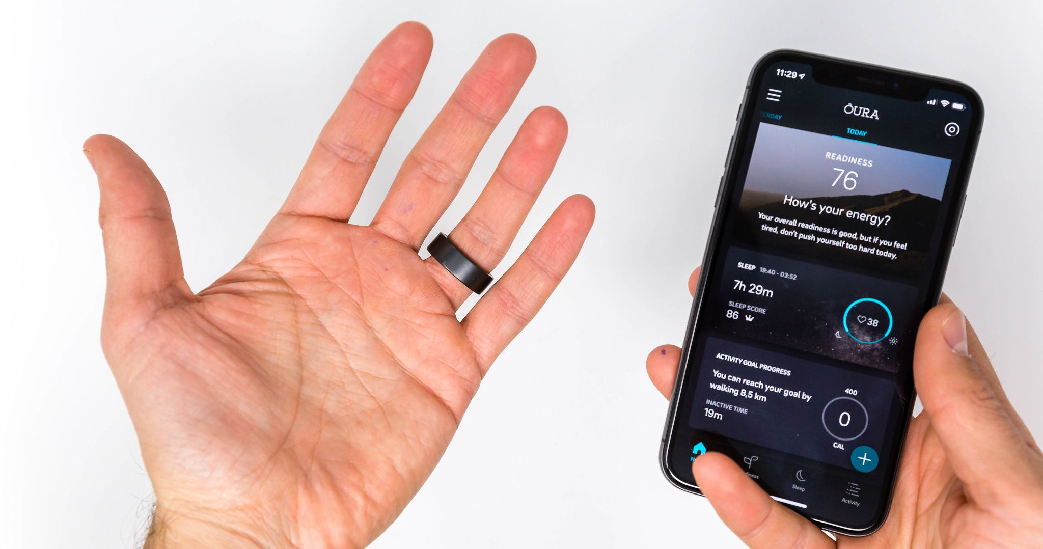 person wearing oura ring and using smartphone app