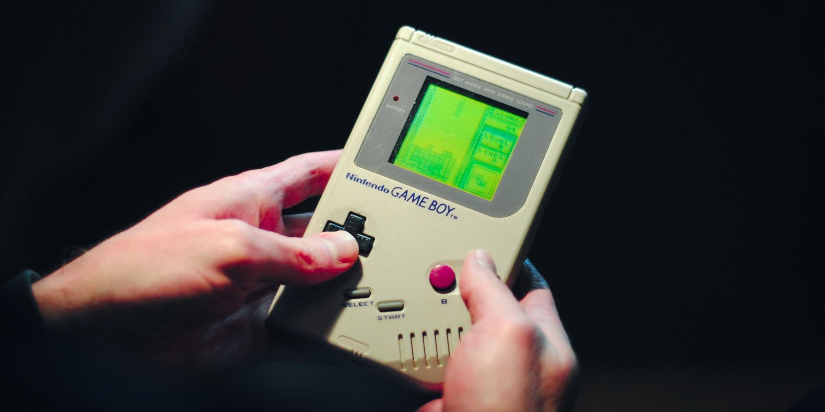 Person holding a Game Boy