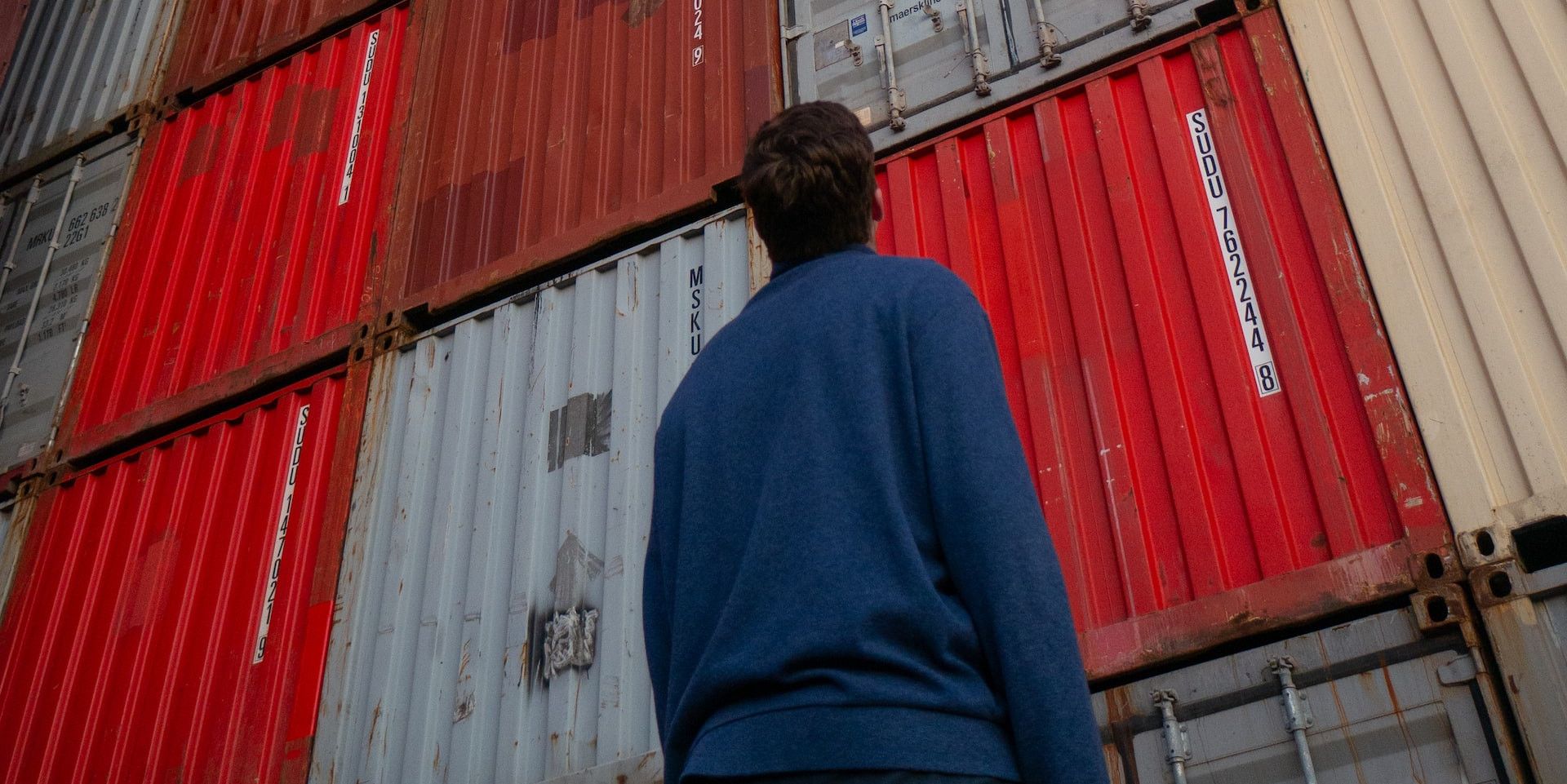 person looking up at containers