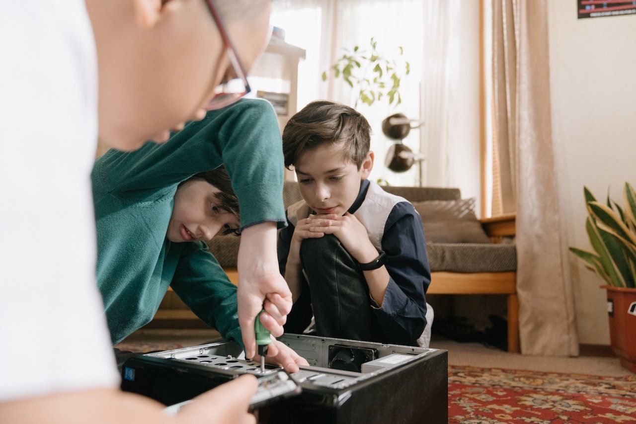 Image of boys fiddling with a computer