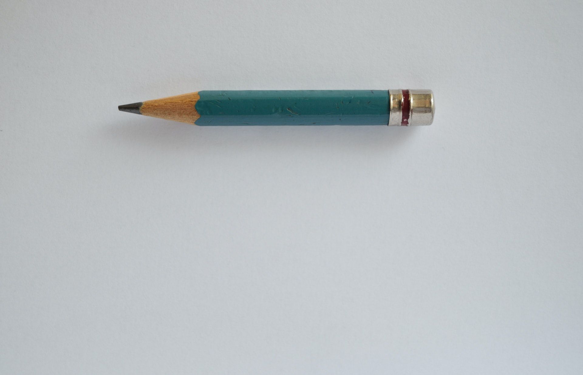 A single pencil on a grey background